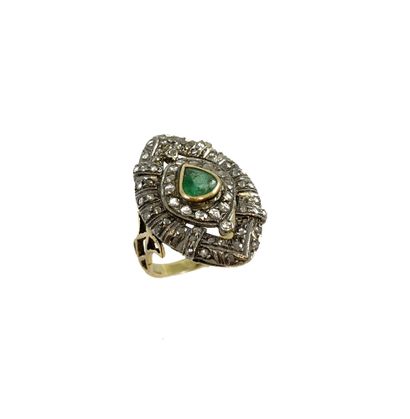 null RING holding a pear-shaped emerald in a shuttle design punctuated with rose-cut...
