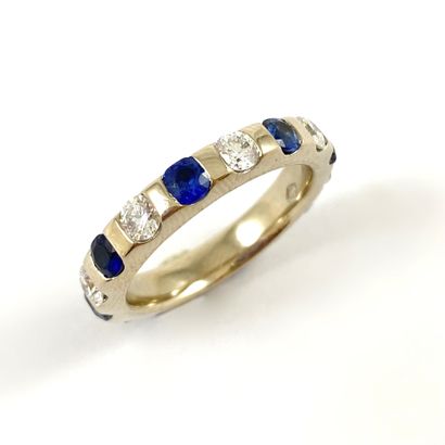 null RING holding an alternation of sapphires and brilliant cut diamonds. Mounted...