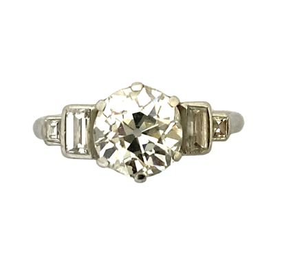 null RING holding a 1.20 carat old cut diamond (a slight chip) with four baguette...