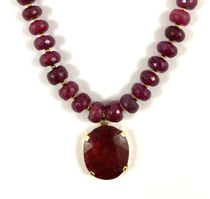 null 
NECKLACE

decorated with faceted ruby beads alternating with gold beads holding...