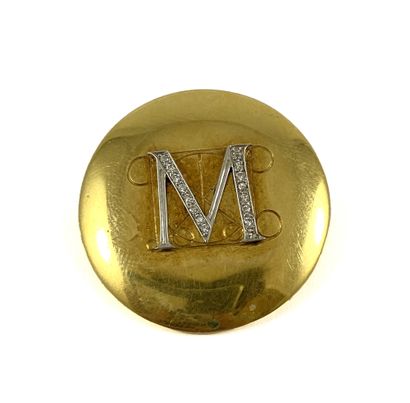 null "Round brooch holding in its center the letter M paved with brilliant cut diamonds...