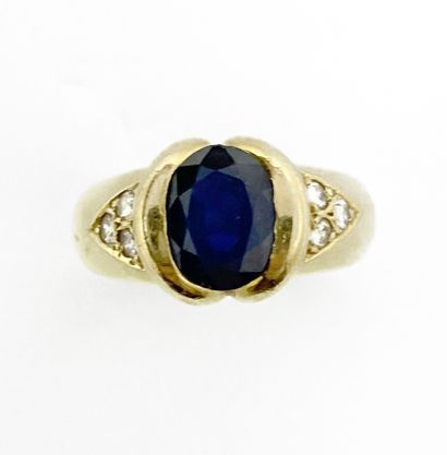null RING holding an oval sapphire of approximately 2 carats in a godronné setting,...