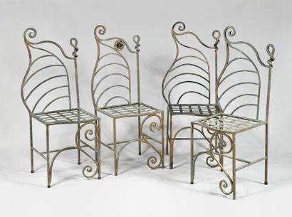 null CONTEMPORARY WORK Suite of four wrought iron chairs, seats and backs wavy, one...