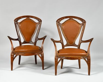 null After a model of JACQUES GRUBER (1870-1936) Pair of carved walnut armchairs...