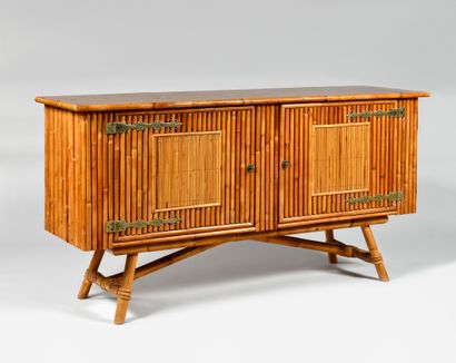 null WORK OF THE 1960S Rattan sideboard opening by two doors with large ironworks,...