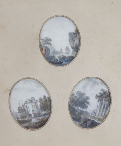 null THREE SMALL OVAL MEDALS, watercolor landscapes. Framed with a gilded wood baguette....