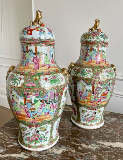  CHINA Pair of Canton enameled porcelain covered vases decorated with palace scenes...
