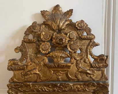 null FRONTIER MIRROR in molded, carved and openwork gilded wood decorated with foliage...