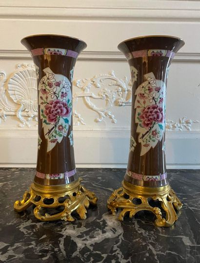  CHINA A pair of Famille Rose porcelain horn vases decorated with peonies in leafy...