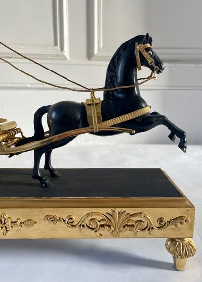 null PENDULE AU CHAR « allégorie de la Louisiane ». En bronze ciselé, doré et patiné,...