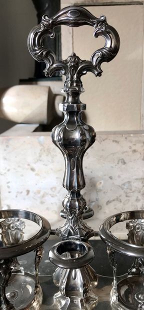  A silver oil and wine cruet, the base resting on four runners, with two decanters....