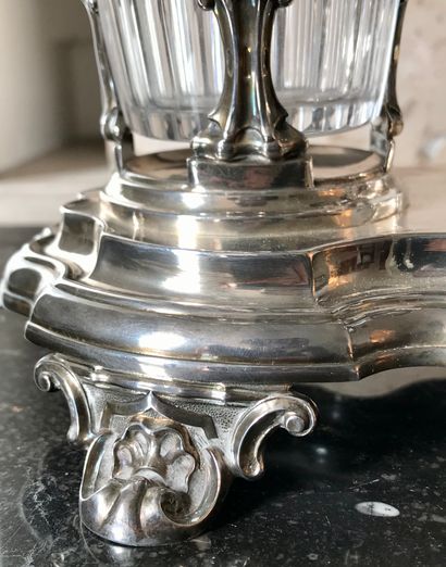 A silver oil and wine cruet, the base resting on four runners, with two decanters....