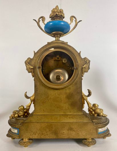 null A bronze and gilded metal CHESTLACE, including a clock and a pair of candelabras...