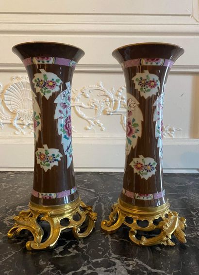  CHINA A pair of Famille Rose porcelain horn vases decorated with peonies in leafy...