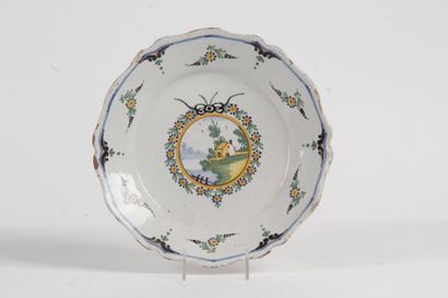 null FAIENCE DISH OF THE 18th CENTURY, decorated with architectural landscape in...