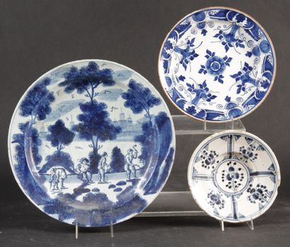 null LARGE DELFT FAIENCE PLAT decorated with four characters in a wooded and architectural...