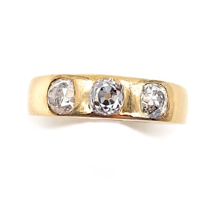 null RING holding a succession of three old cut diamonds of 0.35 carat each. Set...