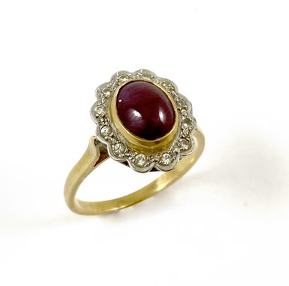 null RING set with a cabochon ruby in a circle of brilliant-cut diamonds. Mounting...