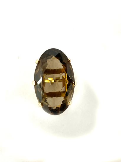 null RING holding an oval smoky quartz of approximately 50 carats. Mounted in 18K...
