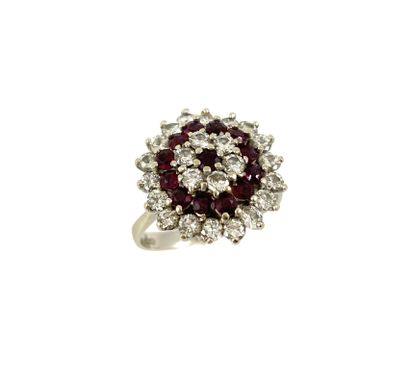 RING decorated with a flower holding a garnet...