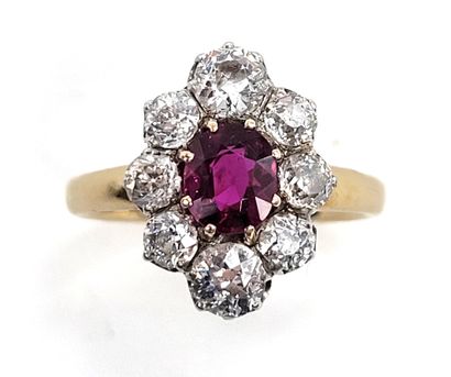 null RING composed of a flower with in its center an oval ruby in a surround of old...