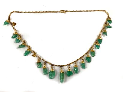 null NECKLACE composed of a succession of plant motifs in carved emerald (accidents)....