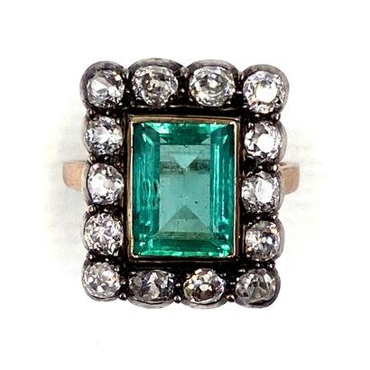 RING holding a rectangular emerald of approximately...