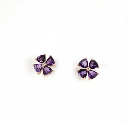PAIR OF EAR PUCKS composed of a flower holding...