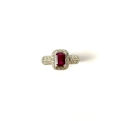 null RING holding a rectangular ruby of 0.70 carat in a paved diamond setting. Mounted...