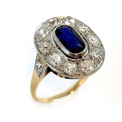 RING holding an oval sapphire in a setting...
