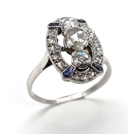 null RING composed of an oval tray holding in its center three rose-cut diamonds...