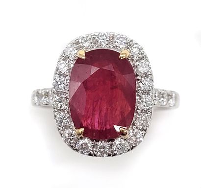 RING holding a 3.47 carat oval ruby in a...