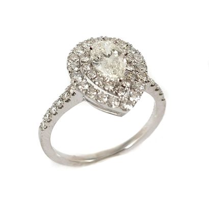 RING holding a 0.70 carat pear-shaped diamond...