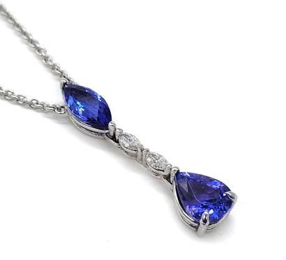 null NECKLACE composed of a pendant holding a tanzanite and two oval diamonds holding...