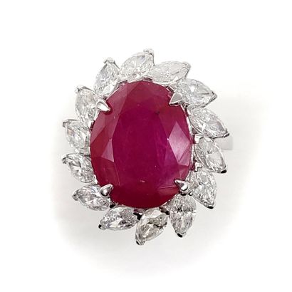 null IMPORTANT RING holding an oval ruby of approximately 9 carats in a surround...