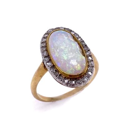 null RING holding an oval opal (important accident) in a surround of rose-cut diamonds.)...
