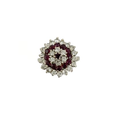 null RING decorated with a flower holding a garnet in its center in a triple surround...