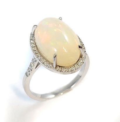 null RING holding an oval opal of 5.94 carats in a surround of brilliant-cut diamonds....