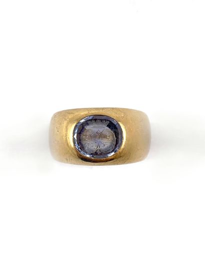 null HORSE RING holding a blue stone in initial with a crowned coat of arms. Mounted...