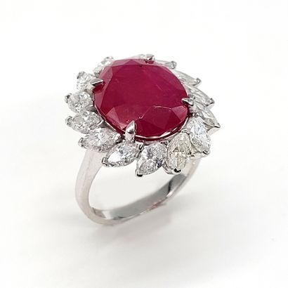 null IMPORTANT RING holding an oval ruby of approximately 9 carats in a surround...