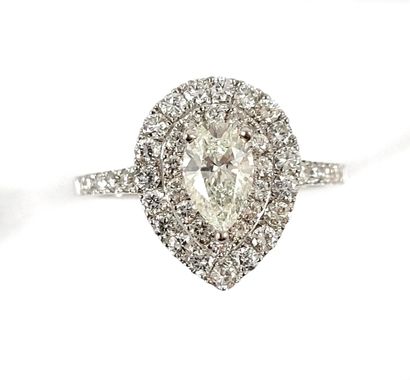 null RING holding a 0.70 carat pear-shaped diamond in a double border of brilliant-cut...