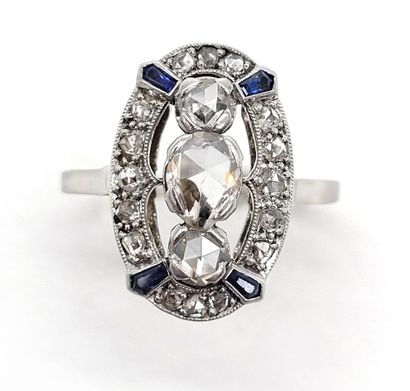 null RING composed of an oval tray holding in its center three rose-cut diamonds...