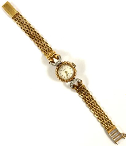 null WATCH adorned with a round dial with a floral motif, baton index. It is set...