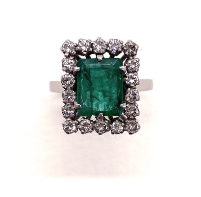 null RING set with a rectangular cut emerald weighing approximately 1.90 carats in...