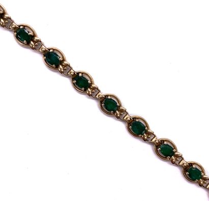 null BRACELET composed of a succession of oval emeralds. Mounting with plant decoration...