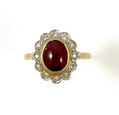 null RING set with a cabochon ruby in a circle of brilliant-cut diamonds. Mounting...