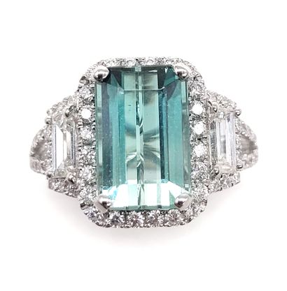 null RING composed of an emerald-cut tourmaline weighing approximately 4.10 carats,...