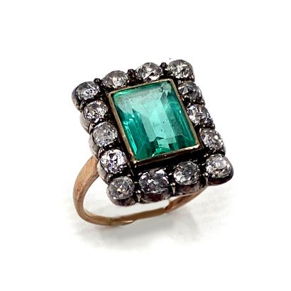 null RING holding a rectangular emerald of approximately 2.90 carats in a setting...