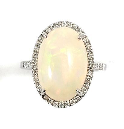 null RING holding an oval opal of 5.94 carats in a surround of brilliant-cut diamonds....