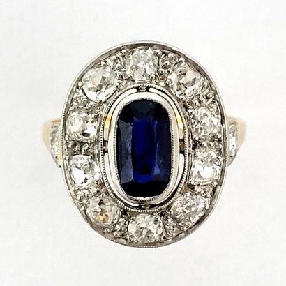 null RING holding an oval sapphire in a setting of old cut diamonds. Set in platinum...